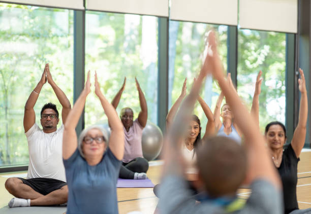 istock Male yoga instructor leads class 1361395466