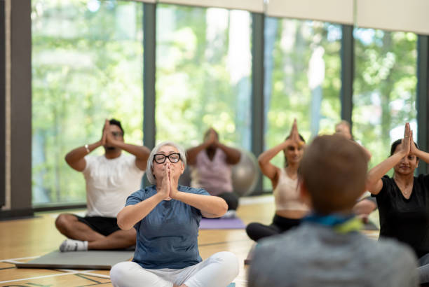 istock Male yoga instructor leads class 1361395476