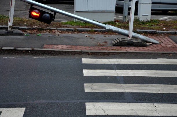 istock There was a car accident and a traffic light at the pedestrian crossing. galvanized pipe post with pedestrian symbol lights lies run over and bent low above the ground, but still glows red 1361397816