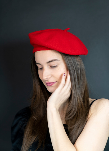 . Model wearing stylish red beret,  Female fashion concep