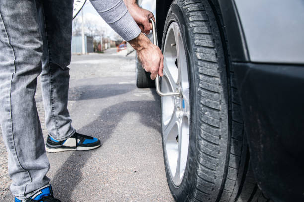 istock changes the wheel of the car 1361401419