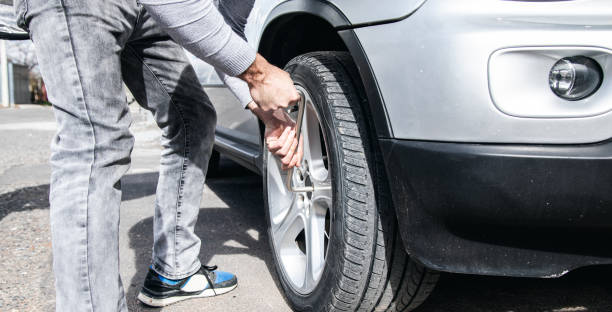 istock changes the wheel of the car 1361401421