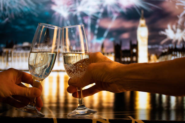 champagne glasses and Big Ben in background New Year's eve in London stock photo