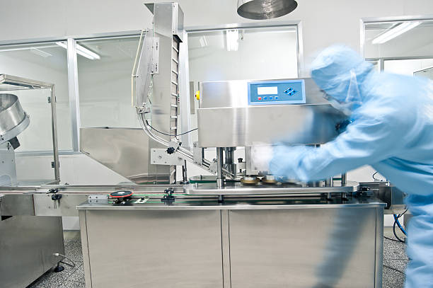 Pharmaceutical technicians are working Pharmaceutical technicians are working cleanroom stock pictures, royalty-free photos & images