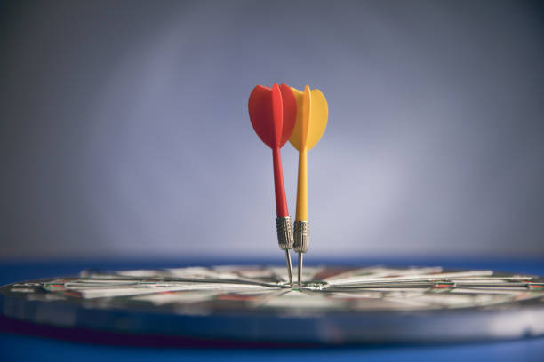 darts in the center of the target darts in the red center of the target dartboard photos stock pictures, royalty-free photos & images