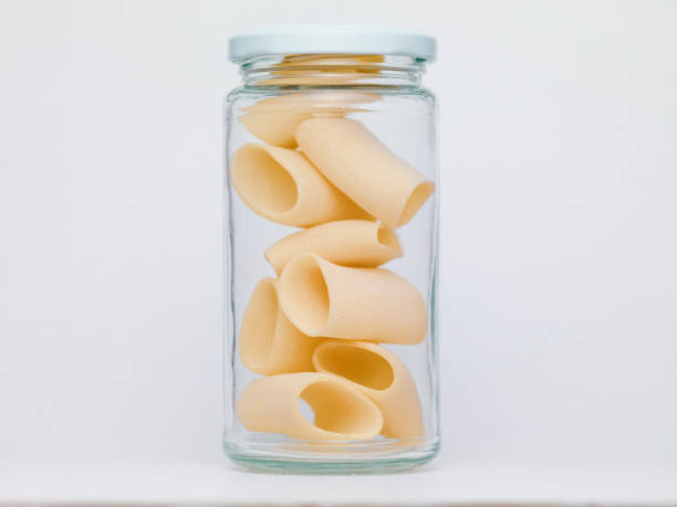 istock Pasta in glass jar on a white background 1361403551