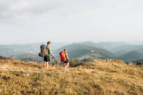 istock Friends hike along grassy mountain ridge 1361404395