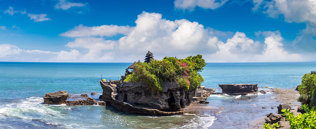Panorama of  Tanah Lot temple on Bali, Indonesia in a sunny day