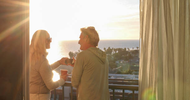 istock Mature couple relax on balcony at sunrise 1361405524