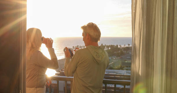 istock Mature couple relax on balcony at sunrise 1361405608