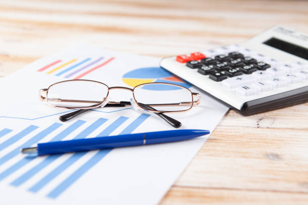 istock on wooden background paper, keyboard and glasses 1361406042