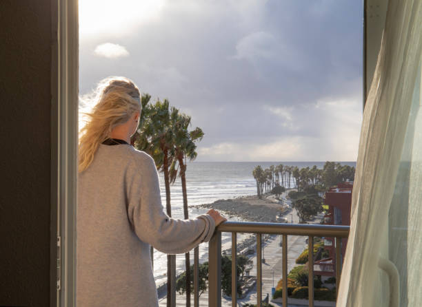 istock Woman relaxes on balcony at sunrise 1361406648