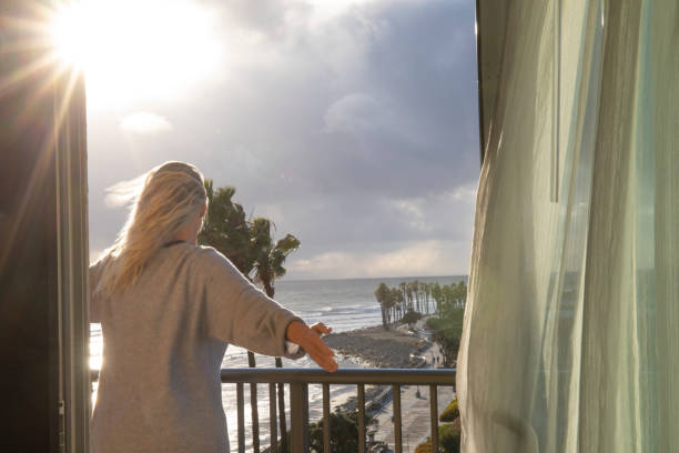 istock Woman relaxes on balcony at sunrise 1361406885