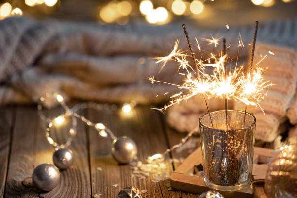 istock Cozy Christmas background with glowing sparklers and decor details. 1361406978