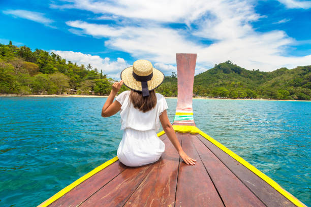 istock Woman on boat in Thailand 1361407681
