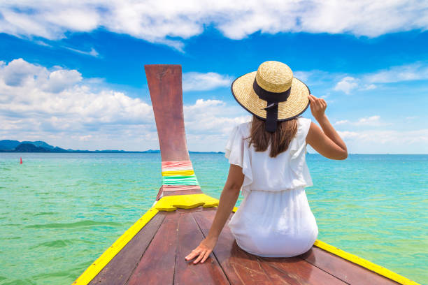 istock Woman on boat in Thailand 1361407700