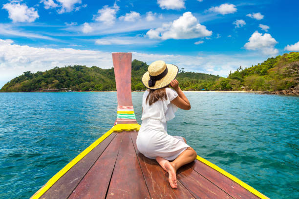 istock Woman on boat in Thailand 1361407714