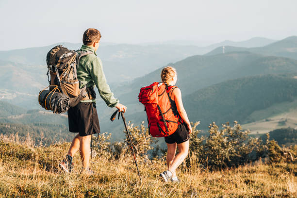 istock Friends hike along grassy mountain ridge 1361407986