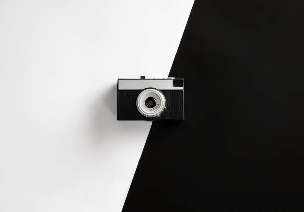 istock Vintage retro camera on black and white background, flat lay. 1361408300