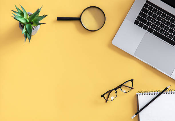 istock Flat lay, workplace, minimalism, yellow background, copy space. 1361408317