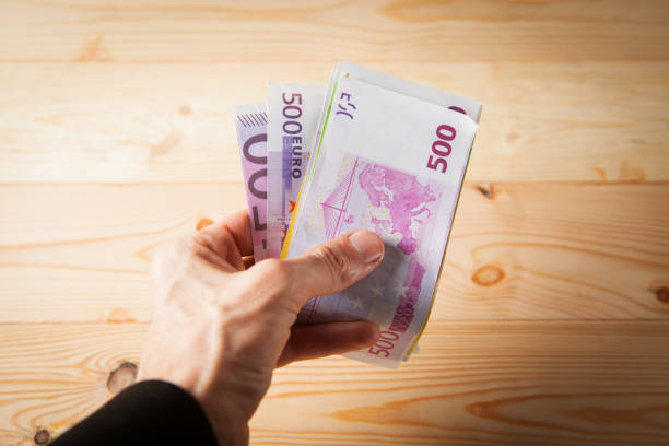 istock holding money in hand 1361409577