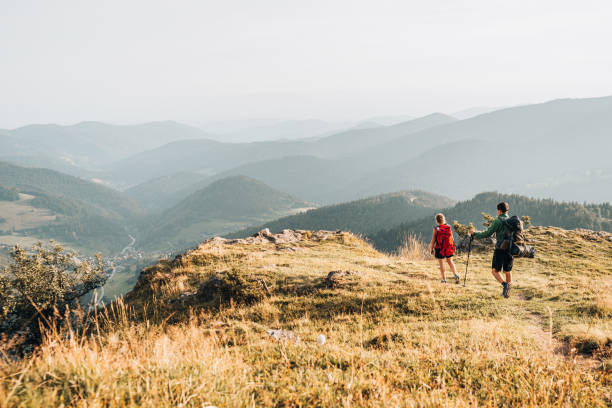 istock Friends hike along grassy mountain ridge 1361409893