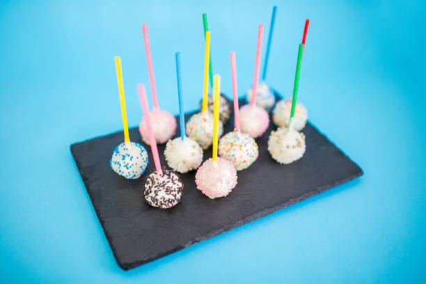Delicious fancy cake pops Sweet cake pops in glaze sprinkled with colorful sugar drops Cake Pop stock pictures, royalty-free photos & images