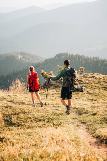 istock Friends hike along grassy mountain ridge 1361411648