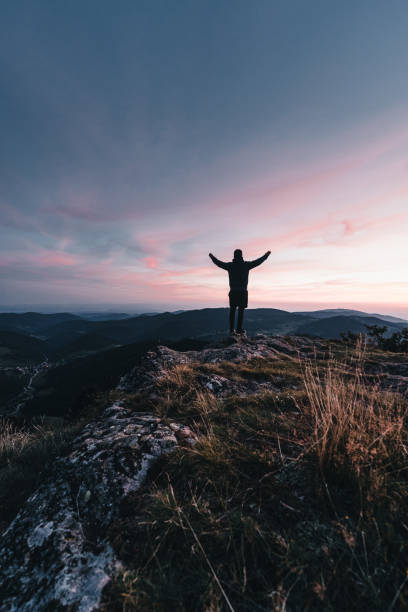 istock Hiker relaxes on mountain ridge, at sunrise 1361411943