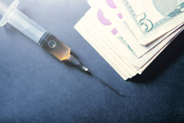 istock syringe and money 1361411948