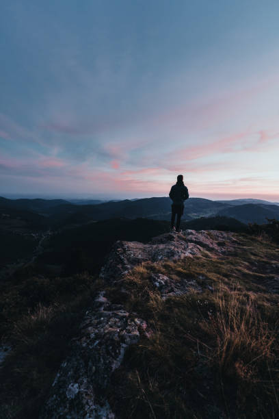 istock Hiker relaxes on mountain ridge, at sunrise 1361412168