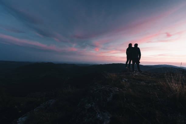 istock Hikers relax on mountain ridge, at sunrise 1361414222