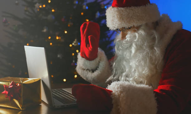 istock Santa Claus is talking on the webcam. 1361415334