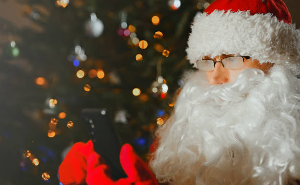 istock Santa Claus make video chat call using the phone. 1361415338