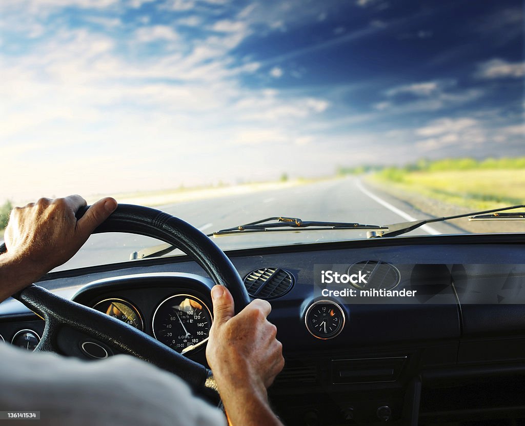 Driver in car Driver's hands on steering wheel of a car Control Panel Stock Photo