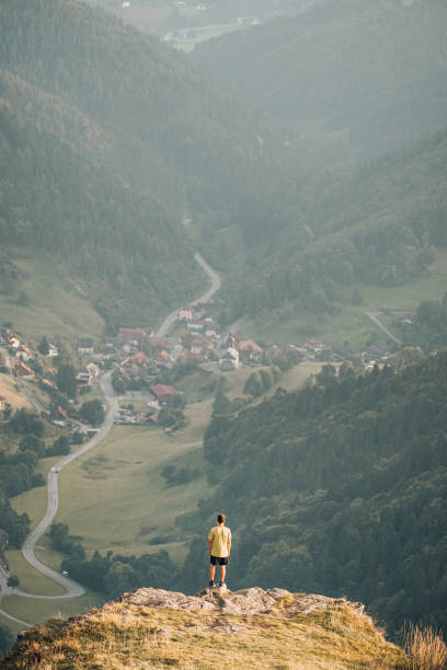istock Hiker relaxes on grassy mountain ridge 1361415374