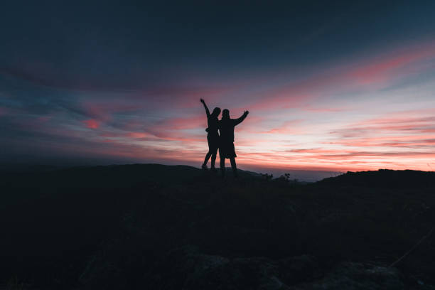 istock Hikers relax on mountain ridge, at sunrise 1361415375