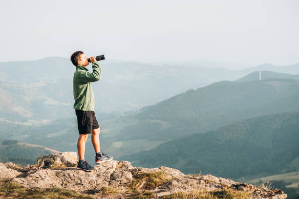 istock Hiker relaxes on grassy mountain ridge 1361415386