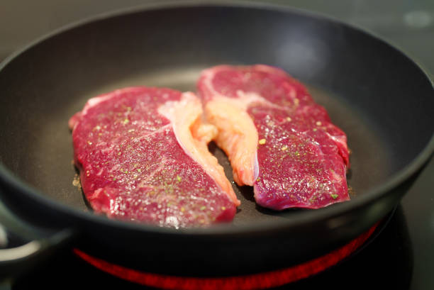 istock Juicy beef tenderloin is cooked in a skillet. 1361415418