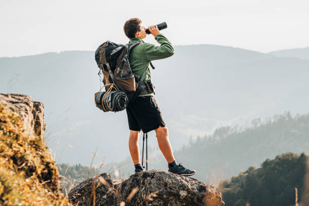 istock Hiker relaxes on grassy mountain ridge 1361415515