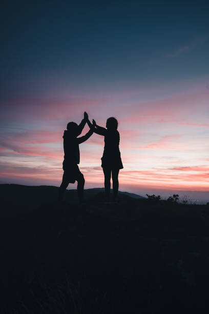 istock Hikers relax on mountain ridge, at sunrise 1361416985