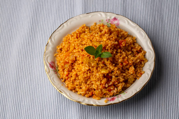 istock Traditional turkish bulgur pilaf with tomato sause in plate (Turkish name; meyhane pilavi) 1361417249