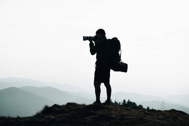 istock Hiker relaxes on grassy mountain ridge 1361417356