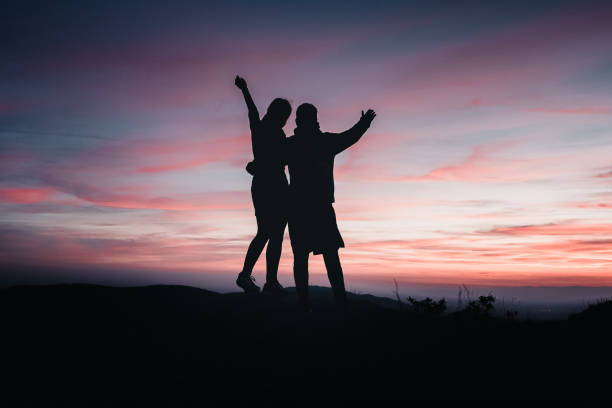 istock Hikers relax on mountain ridge, at sunrise 1361417406