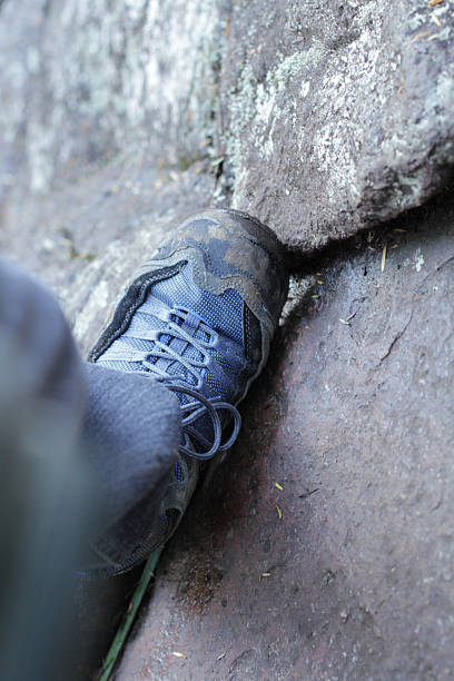 istock Climbing Shoe Wedged in Rock 136141779