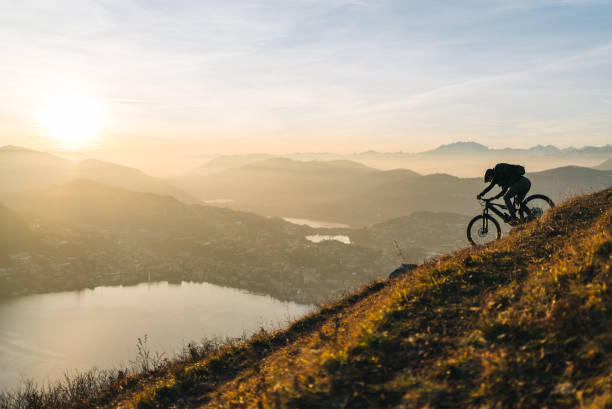 Sun rises over Lake Lugano and the distant Swiss Alps