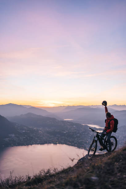 istock Mountain biker relaxes on mountain ridge, at sunrise 1361419292