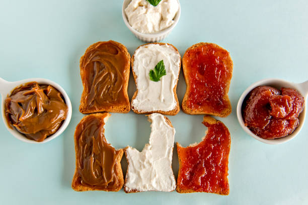 istock Toasted bread with jam, dulce de leche and ricotta cream on blue background. 1361419406
