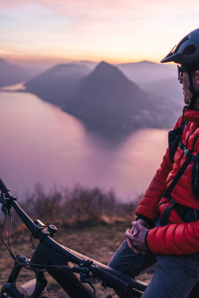 istock Mountain biker relaxes on mountain ridge, at sunrise 1361419522