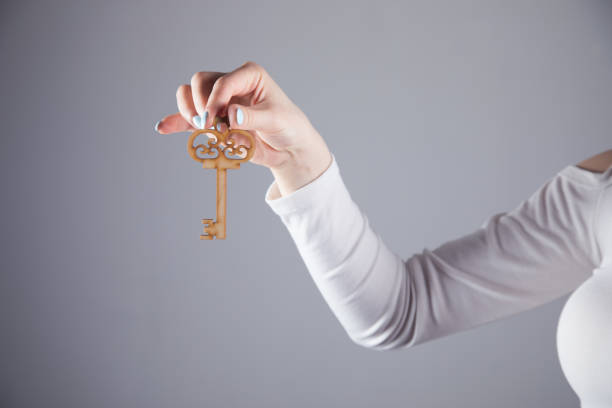 istock young girl holds the key 1361420229